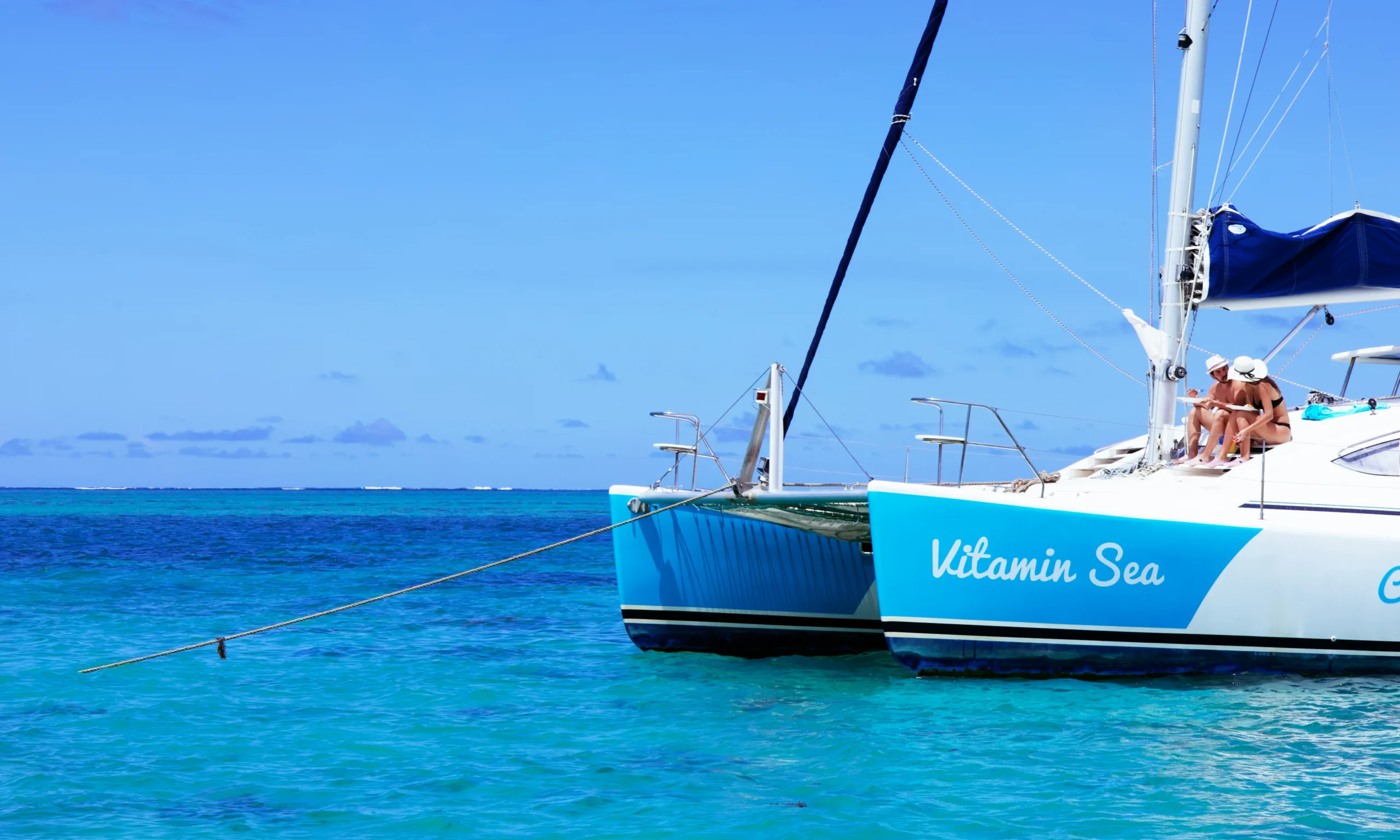 Guests enjoying the view on the deck of a charter yacht